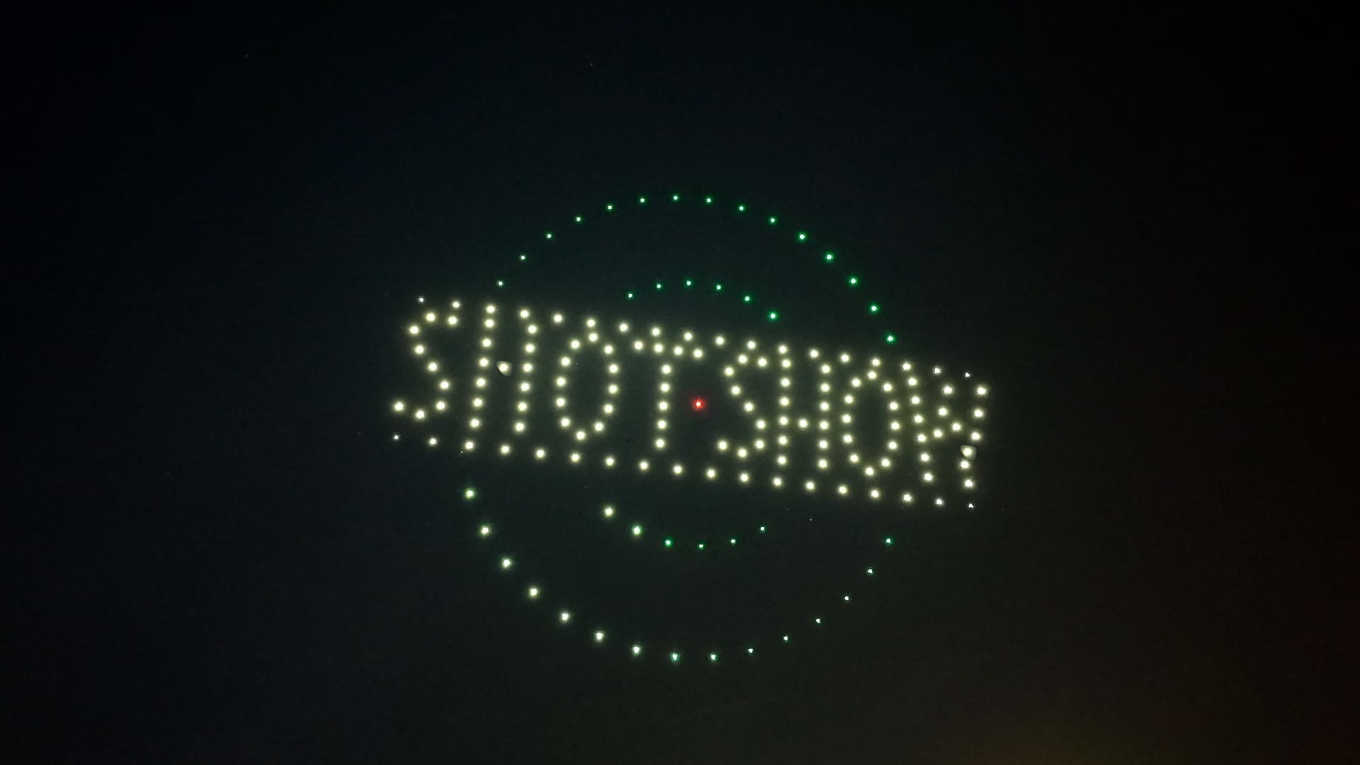 SHOT Show lettering formed by white drones inside green circular formations