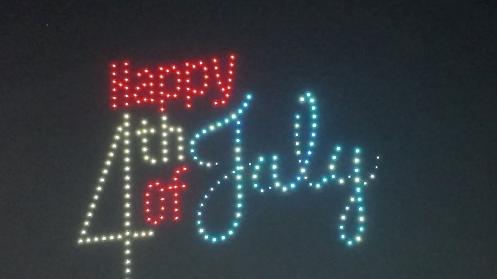Drones spelling Happy 4th of July in red, white, and blue