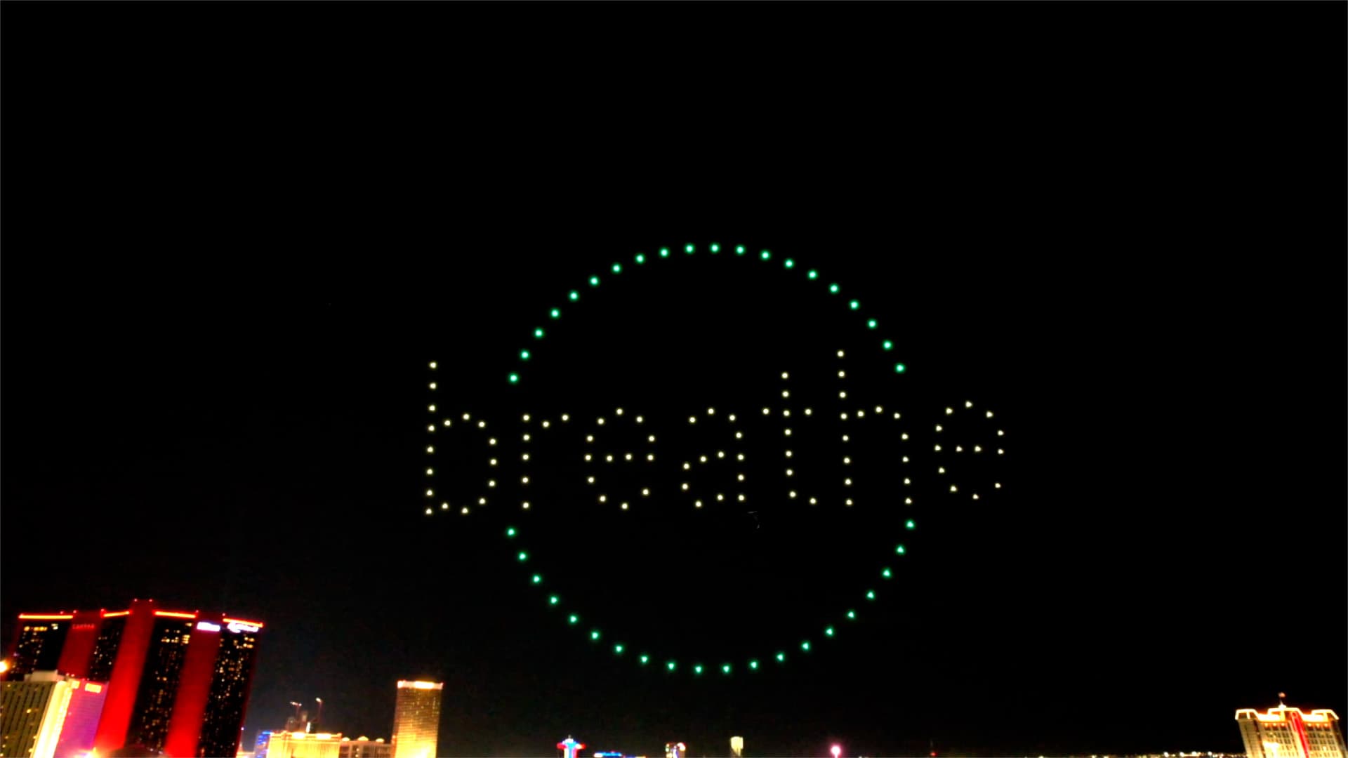 Drones spell breathe inside a green circle over Las Vegas