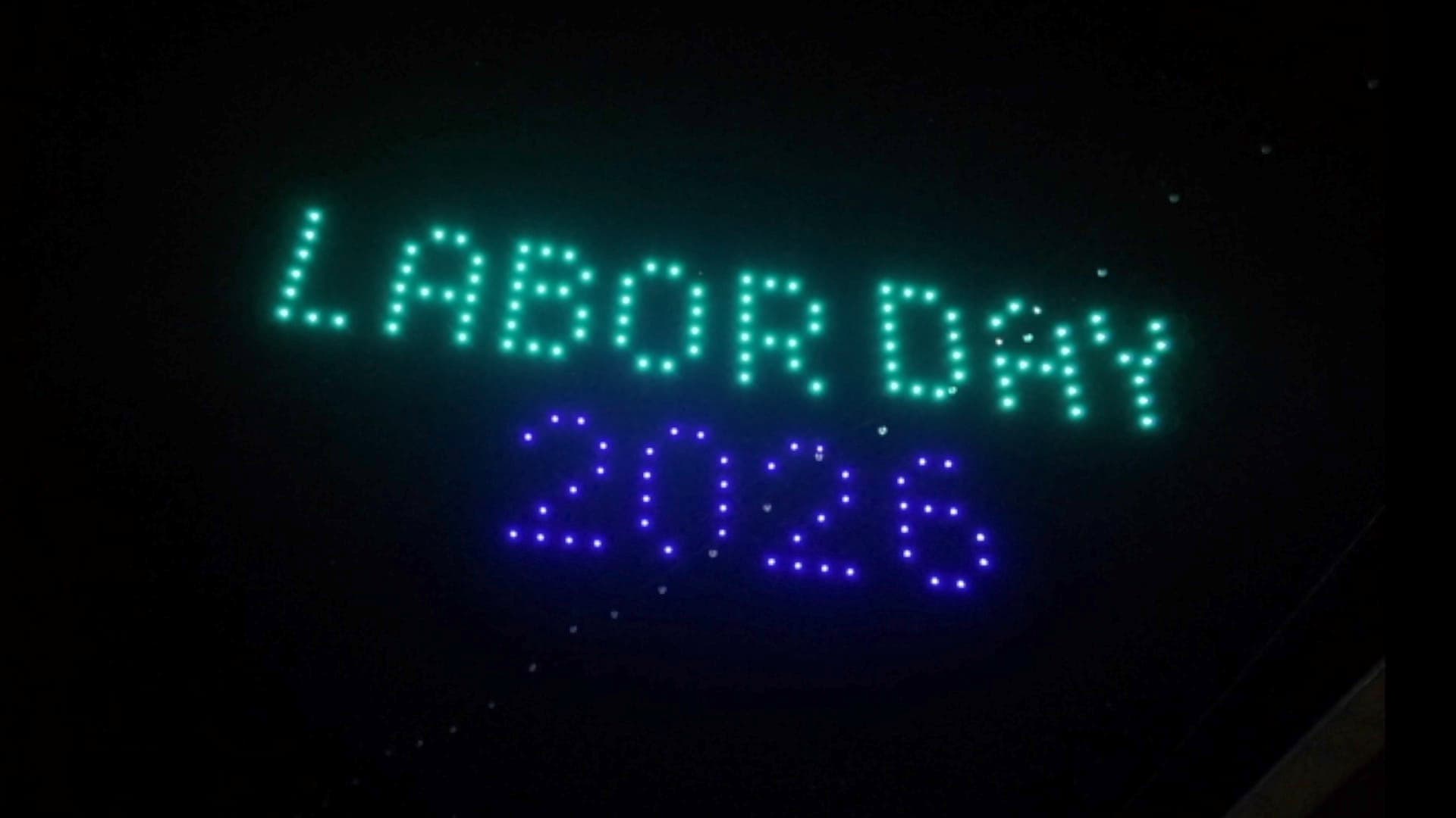 Drones spell Labor Day 2026 in turquoise and purple above Pioche